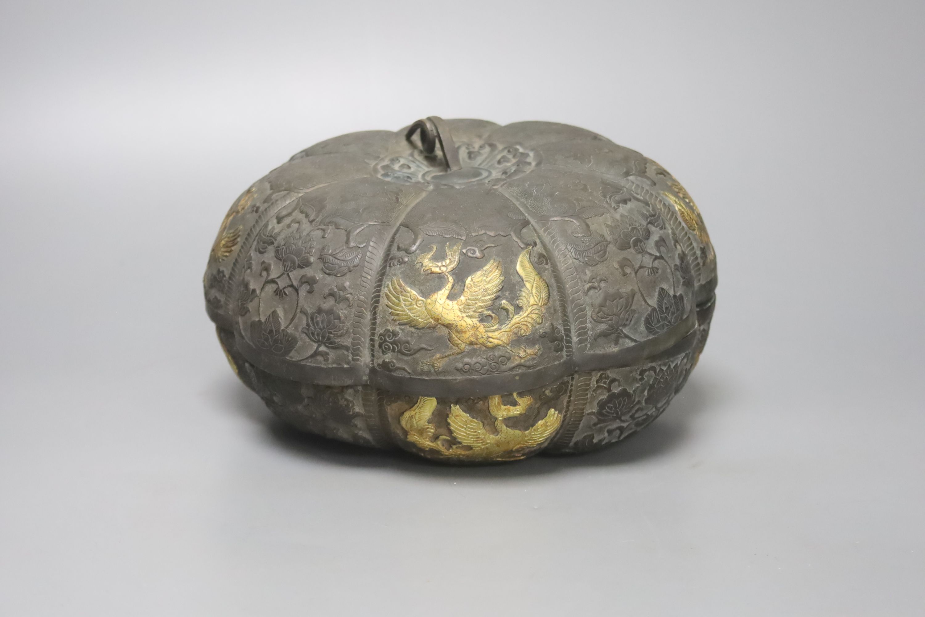 A 19th century Chinese melon-shaped silvered bronze box and cover, applied with gold figures of dragons in flight, Tang dynasty or later, 19cm diameter 10cm high
